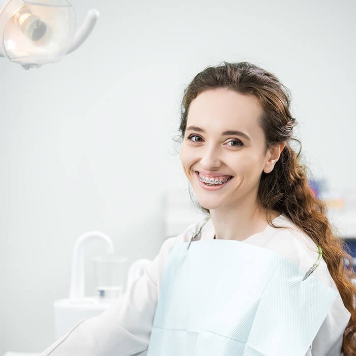 Teenager with braces at orthodontic office